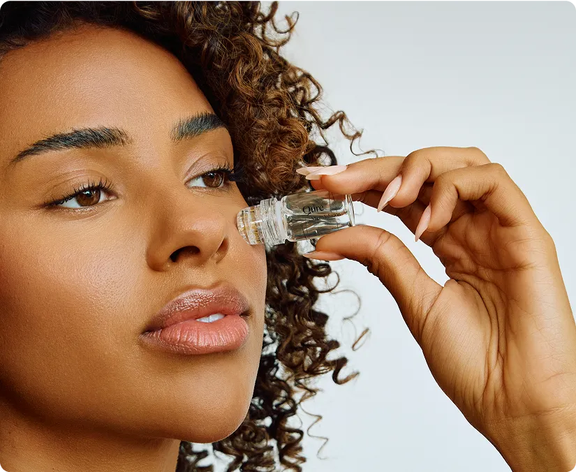 Woman applying face serum