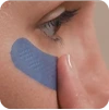 Blue eye treatment mask on face