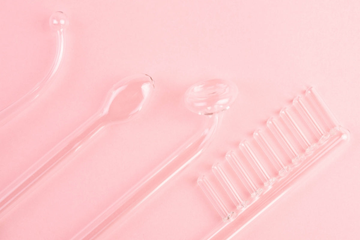 High frequency facial tools on pink background in red light therapy vs high frequency skincare comparison