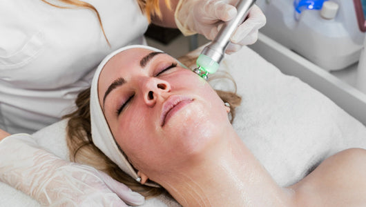 Microcurrent facial treatment in spa setting compared in microcurrent vs red light therapy for skin lifting.