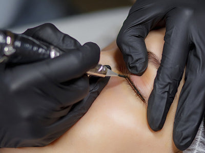 Tattoo artist tattooing permanent eyeliner, raising the question, does red light therapy affect tattoos?
