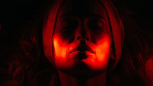 Woman undergoing red light therapy, comparing qure led mask vs dr dennis gross options for at-home skin treatment