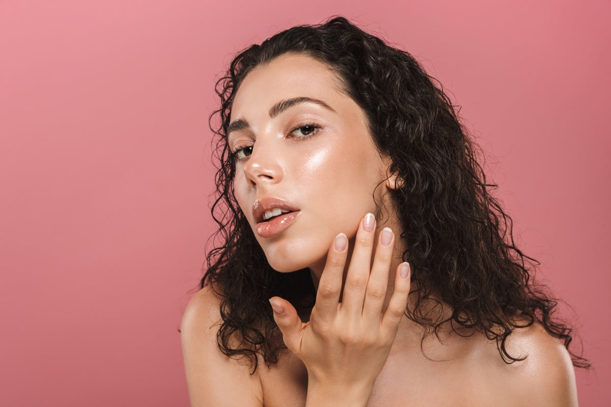 Woman with clear, glowing skin, the kind of result people look for when comparing the qure vs solawave mask