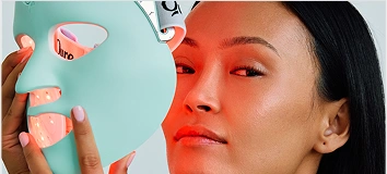Woman with a blue LED light therapy mask.